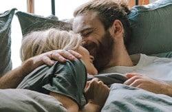 Couple waking up happy together